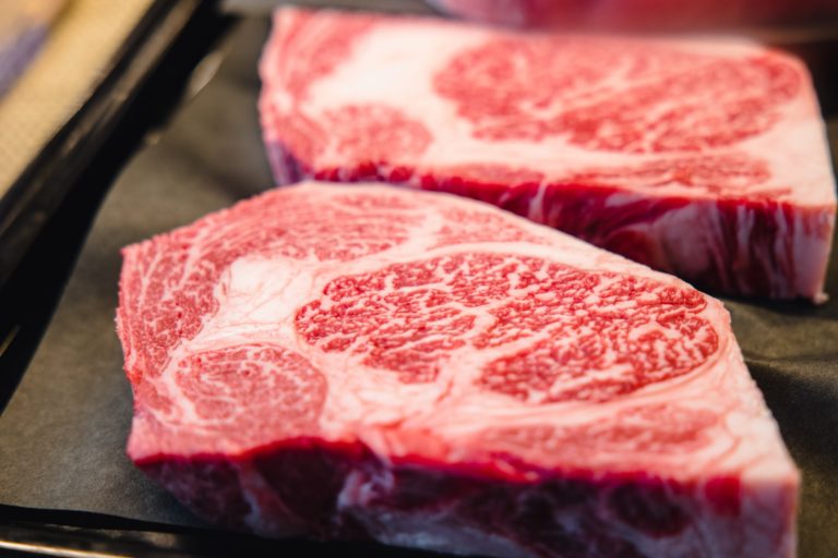 best steak cuts fresh ribeye richly marbled on black plate