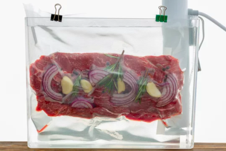 sous vide steak with garlic onion herbs by white cooker immersion circulator with clips