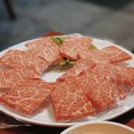 highly marbled wagyu beef slices on white plate