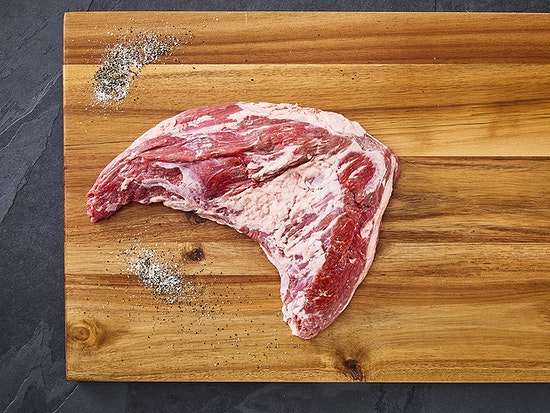 Grass fed Tri Tip Roast on wooden chopping board leanest steak cuts