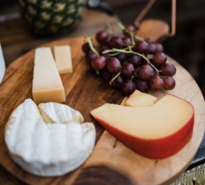 brie washed rind cheeses on wooden board