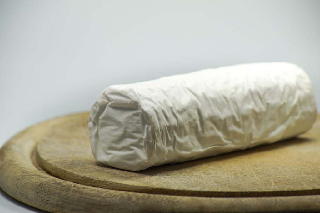 white goat cheese on wooden board