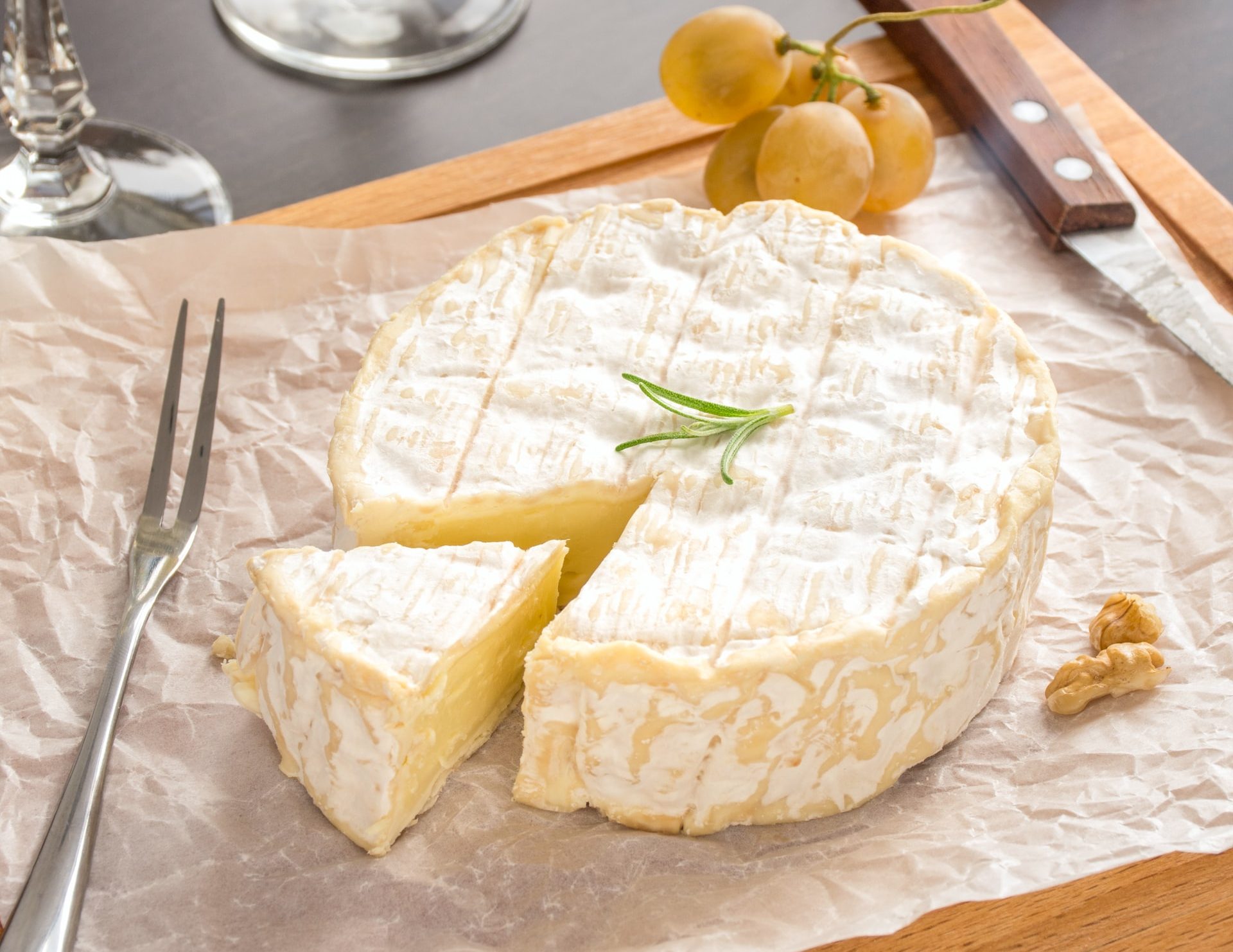 white mold cheese wheel with honey and champagne