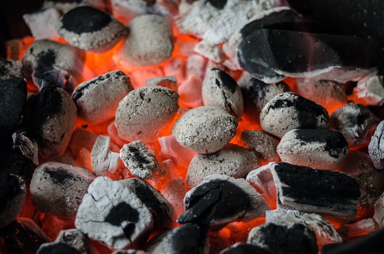 Charcoal briquettes starts to be covered with gray ash