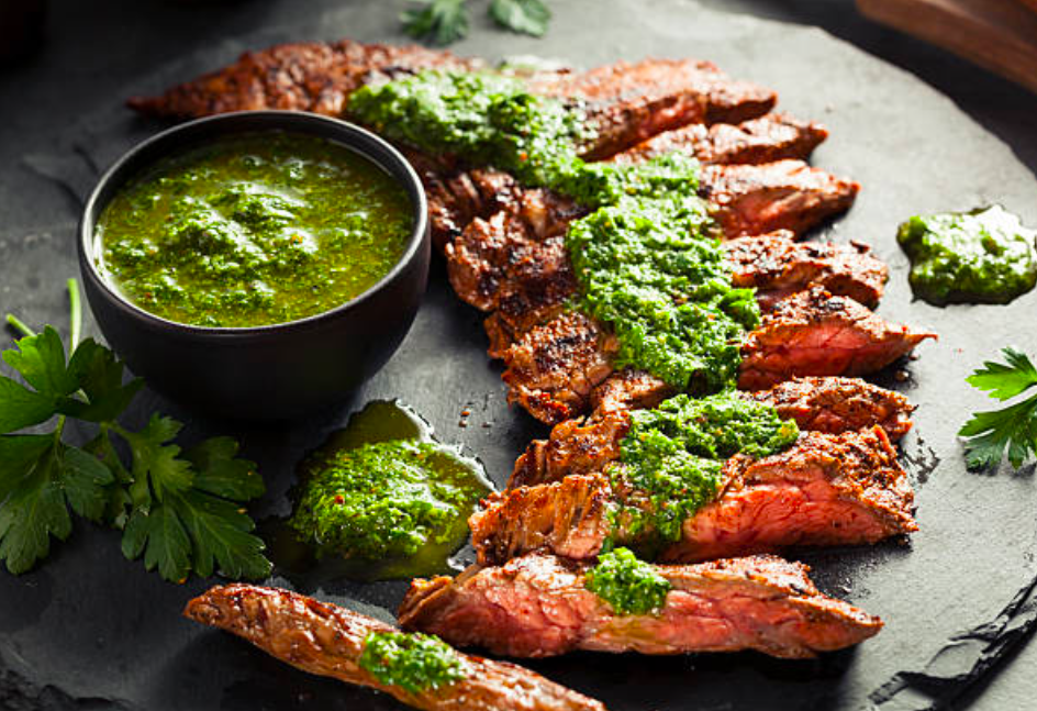 Sliced steaks topped with Chimichurri sauce